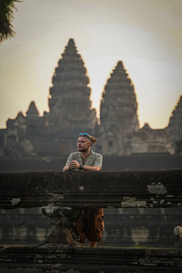 Man posing in front of Angkor Wat during an early morning photoshoot